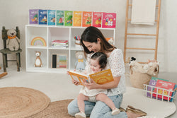 Mom sings along to a bilingual children's book filled with Spanish nursery rhymes with her toddler 
