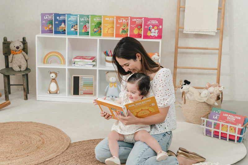 Mom sings along to a bilingual children's book filled with Spanish nursery rhymes with her toddler 