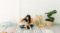 Parent and child bonding over Binibi's bilingual baby books that faciliate spanish learning for kids. 