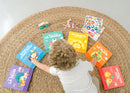 Bilingual toddler choosing which bilingual baby book to read during playtime! 